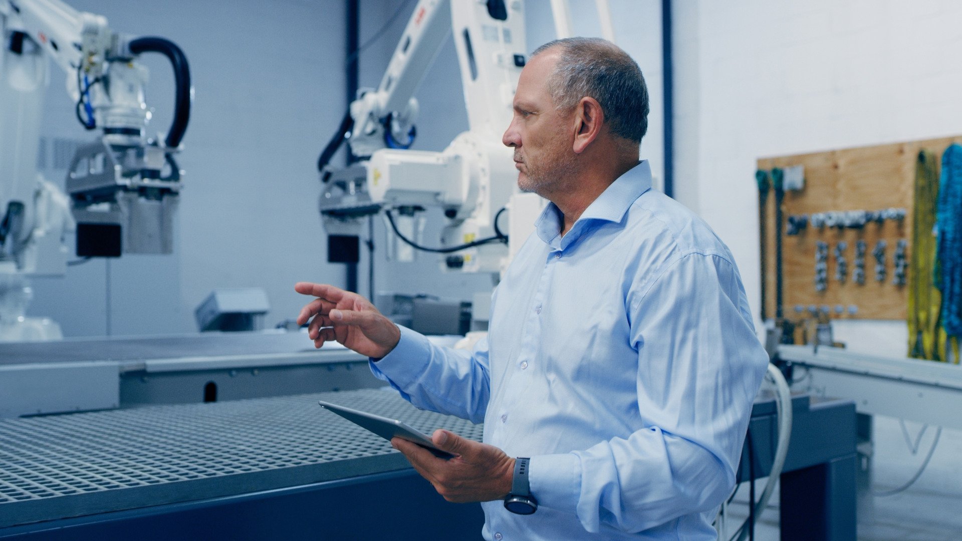 Ein IT-Ingenieur mit Tablet in einer smarten Produktionsstraße